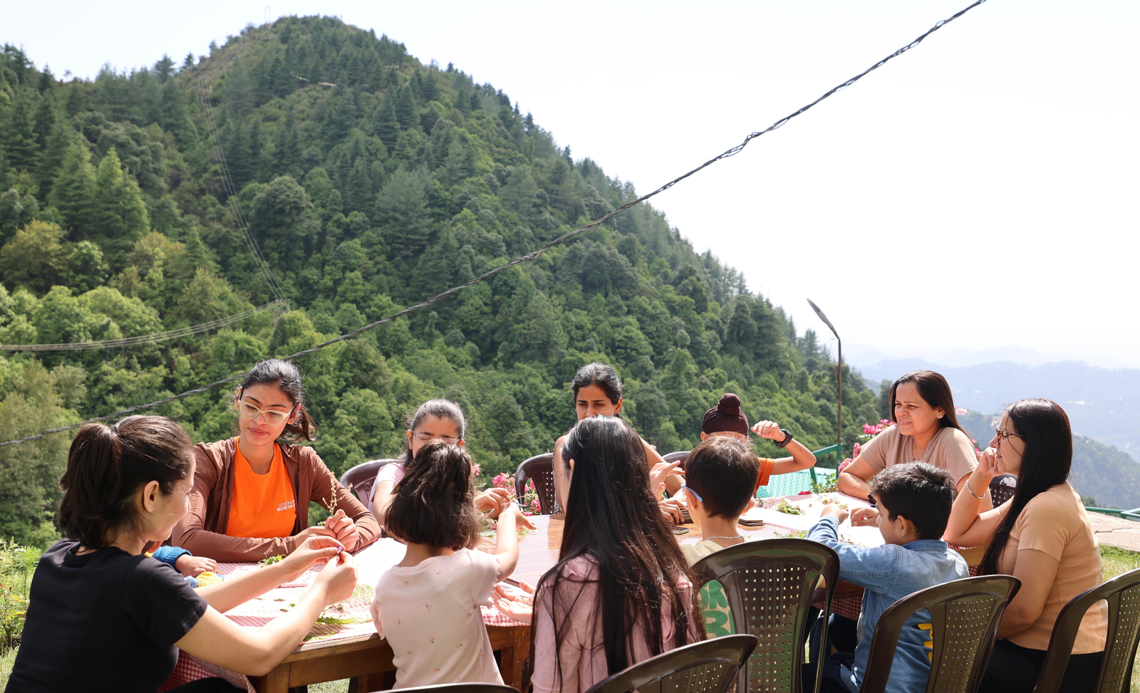 Shilpa Gupta leading an open-air session with children in the hills near Jammu